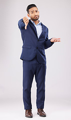 Image showing Portrait, thumbs down and confused business man with negative fail sign, no opinion or decision disagreement. Bad studio service, reject vote gesture or professional person rating on white background