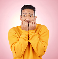 Image showing Anxiety, thinking and asian man biting nails in studio with terror, fear and scared for drama on pink background. Stress, gossip and wtf by male person with horror, fake news or worried about secret