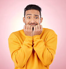 Image showing Anxiety, portrait and asian man biting nails in studio with terror, fear and shocking drama on pink background. Stress, gossip and face of male person with horror, fake news or worried about secret