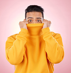 Image showing Eyes, hiding and portrait of man in studio with shocking, fashion and bad news of horror or terror on pink background. Shy, face and person covering anxiety or scared reaction to fear and stress