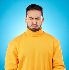 Image showing Face, asian man and holding breath in studio for suspense, fear or stress on blue background. Puff cheeks, air and waiting to breathe by funny male person with countdown, nervous or uncertain emoji