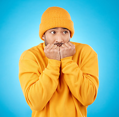 Image showing Nervous, anxiety and asian man biting nails in studio with terror, fear and scared for secret phobia on blue background. Stress, suspense and male person waiting for horror, danger alarm or bad news