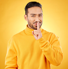 Image showing Secret, man and finger on lips for gossip, confidential information or sign with hand for whisper in studio or yellow background. Announcement, emoji or person for communication or silence of sound
