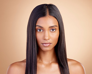 Image showing Portrait, hair care and Indian woman with beauty, cosmetics or texture on a brown studio background. Face, female person or model with cosmetology, shine or scalp treatment with aesthetic or skincare