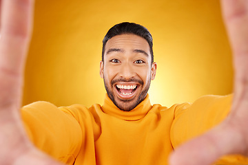 Image showing Excited, portrait and selfie of man in studio isolated on a yellow background. Face, smile and Asian person taking profile picture for happy memory, funny or influencer laughing for social media post