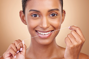 Image showing Woman, dental floss and studio portrait with smile, cleaning and teeth whitening by brown background. Girl, model and happy with dentistry product, string or self care for cosmetics, beauty or health