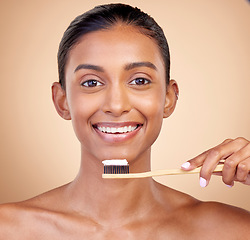 Image showing Woman, wood toothbrush and studio portrait for smile, cleaning and teeth whitening by brown background. Girl, model and happy with bamboo dentistry product, self care and cosmetic beauty with health