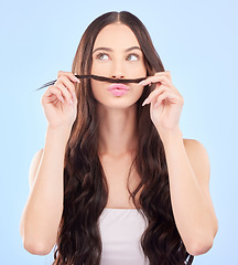 Image showing Hair, moustache and woman in studio for beauty, salon aesthetic or healthy shampoo on blue background. Haircare, face and funny female model with strand of natural waves, texture or keratin cosmetics