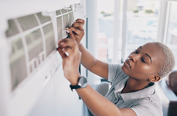 Image showing Black woman, electrician and ac repair for electrical system, fan maintenance and labor. Female mechanic, technician and engineering to fix aircon power, hvac services and air conditioning machine