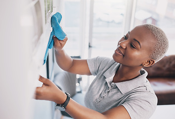 Image showing Cleaning, happy and dust with black woman in living rom for housekeeping, hygiene and disinfection. Janitor, hospitality and cloth with cleaner and washing in home for germ, bacteria and sanitary