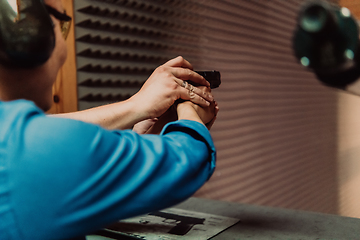 Image showing The trainer explaining to the man how to use the gun. Training in the shooting range