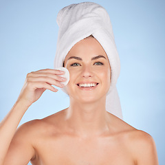 Image showing Bathroom, studio portrait and happy woman with cotton pad for skincare cleaning, self care or foundation. Beauty, face or person with hygiene, wellness and makeup removal product on blue background