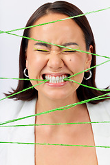 Image showing Crazy, biting rope and a woman on a white background with mental health problem or funny. Stress, young and a model or girl with string for escape or trapped while isolated on a studio backdrop