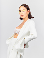 Image showing Portrait, fashion and asian woman in studio with confidence, style and cool clothes against a white background. Stylish, pose and Japanese female model with trendy outfit, attitude and aesthetic