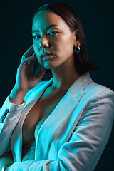 Image showing Neon, beauty and portrait of woman in studio with blue light for stylish, classy or formal fashion. Style, cosmetic and young Asian female model with makeup and fancy blazer by dark black background.