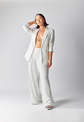 Image showing Suit, style and asian woman with fashion in portrait or confident in studio or white background with luxury outfit. Trendy, elegance and girl with vintage or classy, retro, creative or cool clothes.