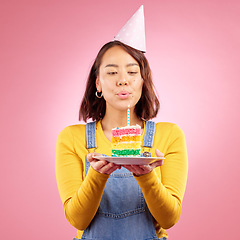 Image showing Birthday cake, studio and Asian woman blow candle, fire or flame for celebration party, present or event gift. Congratulations, wish and Japanese person with dessert, candy or food on pink background