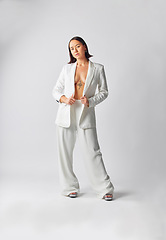 Image showing Portrait, suit and fashion with asian woman with style or full body in studio or white background with cool outfit. Girl, retro and trendy or luxury or vintage clothes with smart casual person.