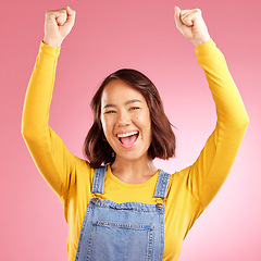 Image showing Happy, celebration and success with portrait of asian woman in studio for party, winner or motivation. Wow, freedom and prize with face of person cheering in pink background for yes, bonus or excited