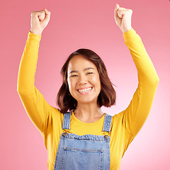 Image showing Smile, celebration and success with portrait of woman in studio for party, winner and motivation. Wow, freedom and prize with face of person cheering in pink background for yes, bonus and excited