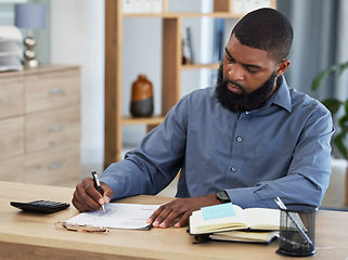 Image showing Black man, planning finance or working on budget in home or remote work, accounting or writing on documents or paper. Tax, audit or businessman in office with financial strategy or accountant