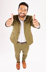 Image showing Thumbs up, portrait and happy business man in studio, white background and trust of success from above. Asian worker, winner and like emoji for feedback, review and vote yes in agreement of support