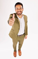 Image showing Thumbs up, portrait and happy asian businessman in studio, white background and success of winning from above. Worker, ok emoji and like sign for feedback, review and vote yes in agreement of support