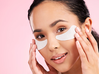 Image showing Beauty, face mask and eye patch of a woman with skin care, dermatology and natural glow. Portrait of a young female aesthetic model with cosmetics product for collagen and detox on a pink background