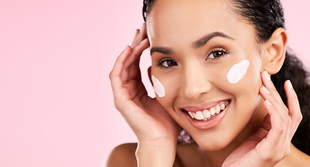 Image showing Face, cream and beauty of a woman with skin care, dermatology and natural glow. Headshot of a young female aesthetic model with space for moisturizer, cosmetics or sunscreen on a pink background