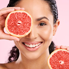 Image showing Grapefruit, beauty and face portrait of a woman with skin care, dermatology and natural glow. A happy young female aesthetic model with fruit for vitamin c, cosmetics or healthy diet and nutrition