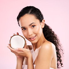 Image showing Woman, portrait and coconut fruit skincare, beauty or vegan cream on pink studio background. Face of african person for natural product and eco friendly dermatology, healthy cosmetics or oil benefits