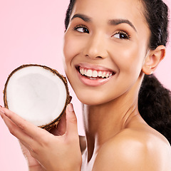 Image showing Coconut, fruit and woman thinking of skincare, beauty or vegan cream on a pink, studio background. Young african person with natural product idea for dermatology and healthy cosmetics or oil benefits