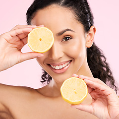 Image showing Woman face, skincare portrait and lemon for beauty, cosmetics and natural product or vitamin c benefits. Happy, young person or model with fruits for eye dermatology on a pink, studio background