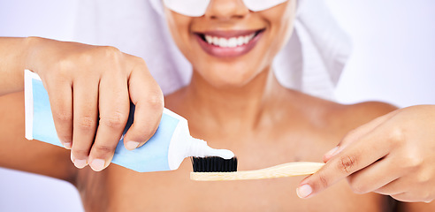 Image showing Toothpaste, toothbrush and woman with an oral care routine in a studio for health and wellness. Smile, dental hygiene and closeup of female model getting ready to brush her teeth by white background.