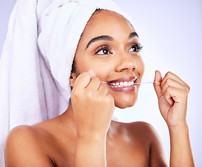 Image showing Tooth, oral care and woman with dental floss in studio for fresh breath, wellness or beauty routine on grey background. Mouth, cleaning and female flossing for cavity, protection and teeth whitening