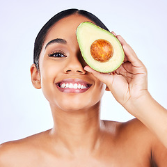 Image showing Skincare, avocado and portrait of Indian woman in studio happy with detox, wellness or omega 3 treatment on grey background. Fruit, face and lady model smile for diy, mask or vitamin c facial beauty