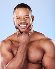 Image showing Skincare, portrait of black man with hand on face, studio and luxury skin care morning routine. Dermatology, spa cosmetics and facial beauty glow for wellness, happy model isolated on blue background