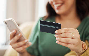 Image showing Phone, credit card closeup and woman hands with online shopping and banking at home. Ecommerce, mobile cashback and sale with digital payment and easy pay with discount and smile from web checkout