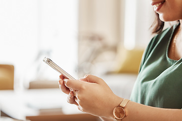 Image showing Hands of woman typing with cellphone in home for social media post, online chat or reading notification. Closeup of female person relax on smartphone, download mobile games or search network for app