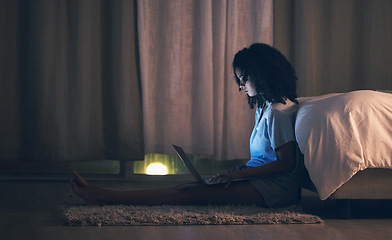 Image showing Laptop, night and woman in her bedroom networking on the internet, social media or website. Technology, dark and female person doing research or browsing online with a computer in her apartment.