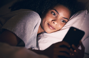 Image showing Happy, night and phone with woman in bedroom for social media app, insomnia and networking. Communication, contact and internet with female person in bed at home for mobile, online and technology