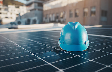 Image showing Construction, building and a hat for solar panel on a roof for engineering or a sustainability job. Future, innovation and a helmet on a power development for a home, maintenance or renewable energy