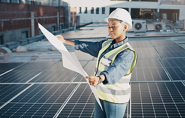 Image showing Female engineer, solar panel blueprint or outdoor on roof for power, sustainability plan and energy development. Black woman, photovoltaic tech and reading on rooftop, building or electricity in city