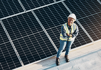 Image showing Woman, solar panel construction and arms crossed portrait with a smile for engineering and green energy. Labor, happy and African female employee on industrial site outdoor for eco project from above