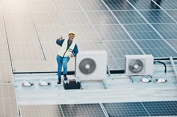 Image showing Engineer woman, solar panel and thumbs up with smile for clean power, sustainability or success on roof. Technician, photovoltaic technology and happy with goal, winner and sign with electricity grid