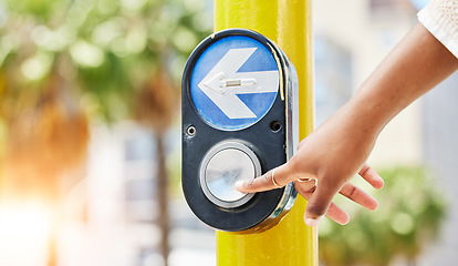 Image showing Crosswalk, arrow and button with hand of woman in city for traffic light, intersection and safety. Travel, sign and stop with person at pedestrian crossing in street for press, transport and warning