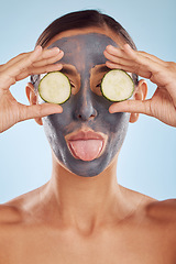 Image showing Face mask, skincare and woman with beauty, cucumber and girl on a blue studio background. Portrait, female person and model with cosmetics, natural and aesthetic with hygiene, charcoal and self care