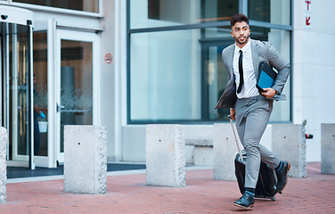 Image showing Businessman outside office, suitcase and running for travel rush, lawyer at law firm for work commute. Folder, luggage and business man on sidewalk, attorney with hurry on city street and late to job