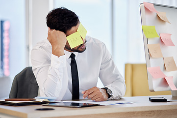 Image showing Tax, problem and business man with sticky note in office for debt, audit or financial crisis on computer. Stress, tired or professional with burnout for mistake, fail or bankruptcy, bills or reminder