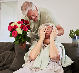 Image showing Senior couple, surprise and flowers gift for love and valentines day in a home. Living room couch, closed eyes and smile with elderly woman and man together in retirement with bouquet in a house